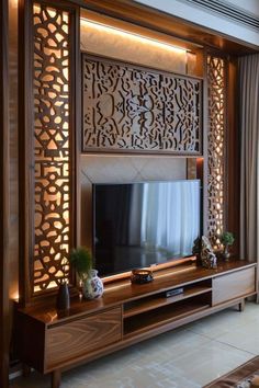 a living room with a large screen on the wall and some plants in vases