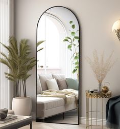 a living room with a couch, mirror and potted plant