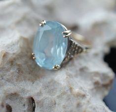 This is the perfect option for those who like cool, unique jewelry and the luxury, shine of yellow gold. This ring is well made, cute and/or elegant in design, and very desirable. Vintage ring decorated with the aquamarine like stone in the center and from the side is decorated with little diamonds . The 3 diamonds are missing. This ring stands out by itself or it is beautiful stacked with others rings. ♥ Age/era: 1980s - 1990s. ♥ The ring is a hallmark. 14K F.M. Franklin Mint. ♥ The ring's size Blue Aquamarine Fine Jewelry, 14k Gold Blue Jewelry With Diamond Accents, Blue 14k Gold Jewelry With Gemstone Accents, 14k Gold Jewelry With Diamond Accents In Blue, 14k Gold Jewelry With Blue Diamond Accents, Classic Light Blue Jewelry With Diamond Accents, Fine Jewelry For Anniversary In Light Blue, Fine Jewelry With Light Blue Accent Stones, Light Blue Aquamarine Jewelry With Diamond Accents