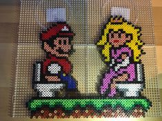 two pieces of lego art made to look like mario and princess zeldas sitting on top of each other