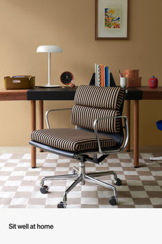 an office chair sitting on top of a checkered floor next to a wooden table