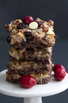 three dessert bars stacked on top of each other with cherries and white chocolate chips