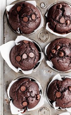 six chocolate muffins sitting on top of a pan