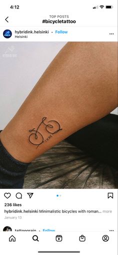 a person with a bike tattoo on their arm and the word bicycle written in black ink