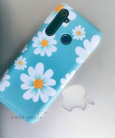 the back side of a blue flowered case with white and yellow flowers on it