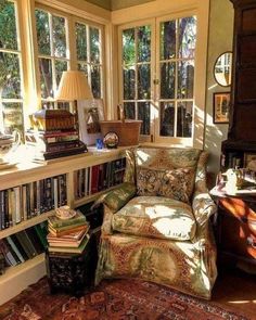 a living room filled with lots of books and furniture