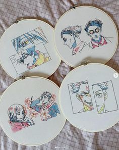 four embroidery hoops with pictures of people in them on a sheet covered bed,