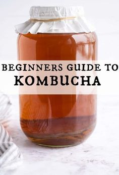 a jar filled with kombucha sitting on top of a table