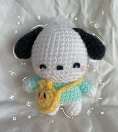 a crocheted stuffed animal with a banana in it's mouth on a white sheet