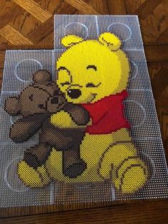 a mesh screen with a teddy bear holding a teddy bear