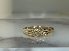 a close up of a gold ring on a table