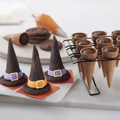 there are many cones with witches hats on them and some cookies in the shape of ice cream cones