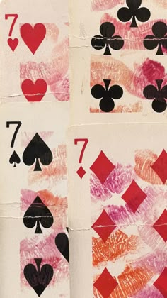 four playing cards with hearts and spades drawn on them