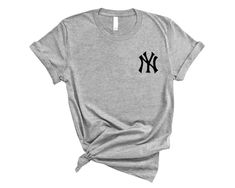 a gray t - shirt with the new york yankees logo in black ink on it