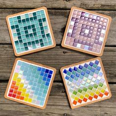 four coasters with different colored tiles on them