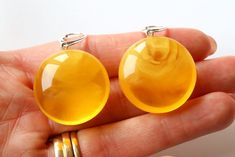 The earrings of Baltic amber in rich yellow colour will not betray your expectations. Executed in the shape of a drop, they will perfectly match to any outfit. These lightweight, elegant, classic earrings are an irresistible piece of jewellery that you will love wearing every day. It is a genuine, natural and unique piece of jewellery created by nature, so you will feel special on every occasion. Delight yourself or your loved one with a little miracle from nature.  Earrings length with clasp: 4 Modern Yellow Baltic Amber Jewelry, Baltic Amber Jewelry, Nature Earrings, Amber Earrings, Yellow Colour, Classic Earrings, Amber Beads, Amber Jewelry, Gift For Wife