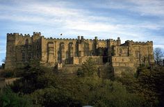 an old castle sitting on top of a hill