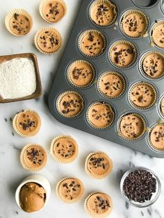 cupcakes with chocolate chips and sprinkles on a marble counter top