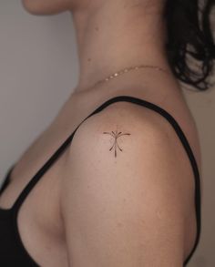 a woman with a small tattoo on her shoulder