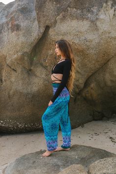 Gorgeous turquoise yoga pants with mandala pattern and a cute side pocket. These trousers are so lightweight and comfortable.  They have a stretchy, elasticated waistband so they fit a range of sizes and are elasticated around the ankles making the leg length adaptable.   They're a popular choice for festival goers as they dry so fast and are a great choice for yoga, dancing or just lounging around the house. Measurements:  XS Total Length - 40"/ 101cm Inside Leg - 28"/ 71cm  Waist (Unstretched) Bohemian Blue Pants For Vacation, Blue Bohemian Full Length Pants, Bohemian Style Full Length Blue Pants, Blue Hippie Pants For Vacation, Blue Hippie Harem Pants With Pockets, Hippie Blue Pants For Vacation, Bohemian Blue Wide Leg Yoga Pants, Bohemian Style Blue Wide Leg Yoga Pants, Hippie Blue Bottoms With Pockets