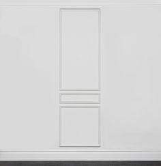 an empty room with white walls and wooden floors