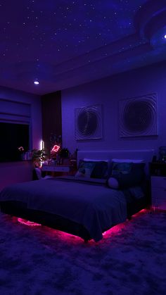 a bed room with a neatly made bed and purple lights on the ceiling above it