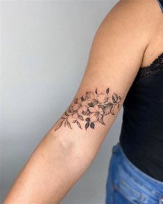 a woman with a flower tattoo on her arm