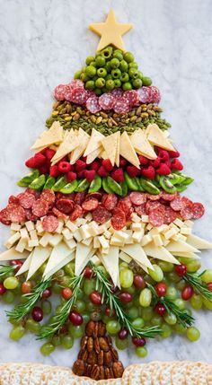 a christmas tree made out of cheese, grapes and nuts