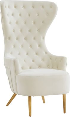 an upholstered white chair with wooden legs and buttons on the armrests