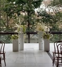 there are several vases with flowers in them sitting on the floor next to each other