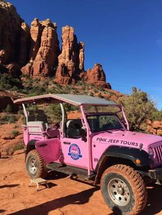 a pink jeep parked in front of some red rocks and trees with the word pink jeep tours written on it