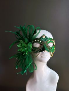 This women's masquerade mask features a rich green base highlighted with intricate gold embellishment and an elegant green floral feather. This mask is the perfect accessory for masquerade parties, balls, Mardi Gras, and other extravagant events! Age Group/Gender - Adult/Women Size/Type - One size fits all adults Mask Color - Green/Gold Mask Material - Polyresin Special Features - Feathers Green Masquerade Mask, Riddler Costume, Mardi Gras Kid, Kids Party Packs, Masquerade Outfit, Theme Nights, Masquerade Ball Mask, Feather Mask, Masked Ball