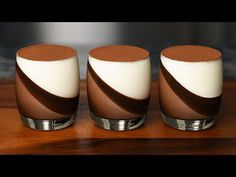 three brown and white vases sitting on top of a wooden table