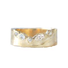 a gold ring with three diamonds on it