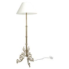 a floor lamp with a white shade on it