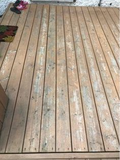 an old wooden deck is being repaired and sanded