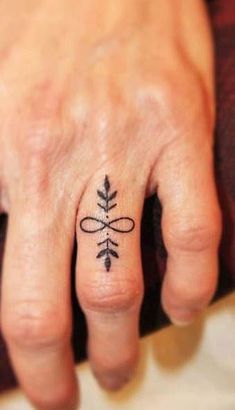 a woman's hand with a small tattoo on it