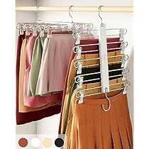 a rack with pants and skirts hanging from it