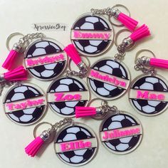 six personalized soccer keychains with tassels and name tags on them