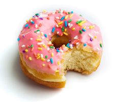 a donut with pink frosting and sprinkles