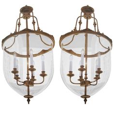 two antique brass chandeliers with clear glass shades