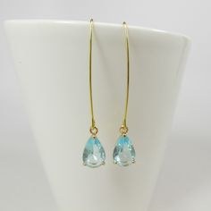 Aqua Blue Drop Earrings, Gold Aquamarine Teardrop Earrings, Long Dangle Earrings, Wedding Jewelry, Bridesmaid Gift, Long Drop Earrings. These beautiful and elegant long dangle drop earrings made with high quality, sparkly 24k gold framed, faceted aqua blue teardrop glass crystals hang from tarnish resistant long oval gold plated ear hooks. These earrings are classic and elegant. Will make an excellent gift for yourself or friends. Measurements: The total length from the top of the hook to bottom Delicate Teardrop Linear Earrings For Anniversary, Yellow Gold Teardrop Linear Earrings For Wedding, Wedding Yellow Gold Linear Teardrop Earrings, Gold Briolette Teardrop Earrings For Wedding, Yellow Gold Drop Linear Earrings For Wedding, Elegant Teardrop Threader Earrings For Wedding, Yellow Gold Long Drop Earrings For Wedding, Delicate Yellow Gold Threader Earrings For Wedding, Wedding Yellow Gold Drop Threader Earrings