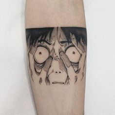 a man's leg with an evil looking face and eyes on his left calf