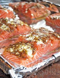 some salmon fillets are sitting on tin foil