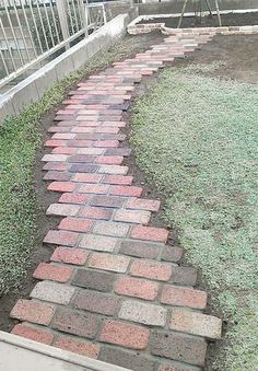 a brick path in the middle of a yard