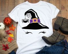 a t - shirt with a witch's hat on it next to pumpkins