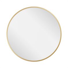 a white and gold round mirror on a wall