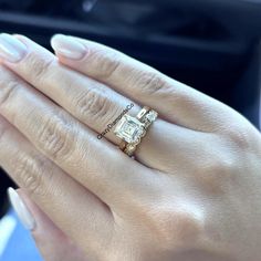 a close up of a person's hand with a ring on it