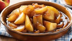 a bowl filled with sliced apples on top of a table