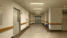 an empty hospital hallway is shown in this image